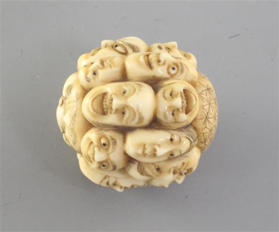 A Japanese ivory multi mask okimono, 19th century, 3.7cm (no. 521)